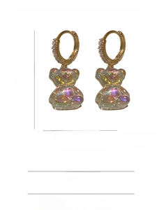 Detail view of colorful resin teddy bear earrings with zircon-studded gold hoops