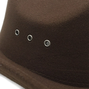 Macro shot of dark brown felt cowboy hat with three silver metal eyelets and stitching