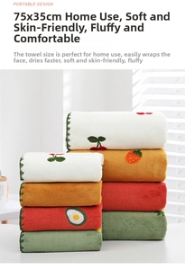 Close-up of soft coral fleece towels with cute fruit embroidery and wavy lace edges