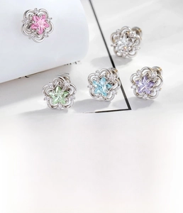 Macro shot of 5-color star zircon cartilage studs with hollow floral titanium settings