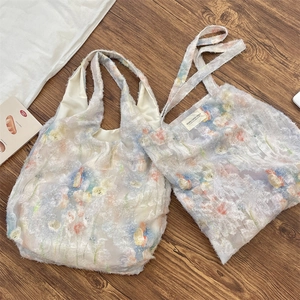 Close-up of floral tote bag with unique 3D feather texture and romantic lace design