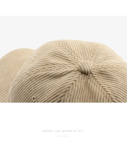Detailed macro view of the khaki corduroy baseball cap crown and reinforced stitching