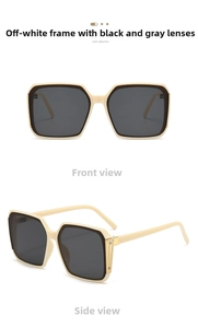 Detail view of beige square sunglasses with dark grey lenses and gold metal accents
