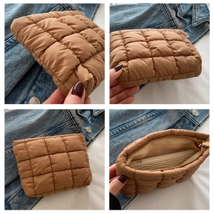 Quilted brown cosmetic bag with grid texture showing interior space and gold zipper