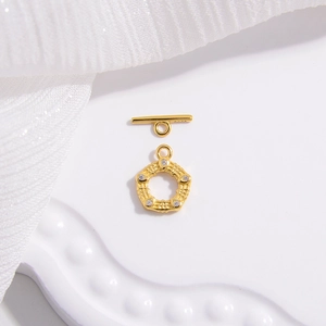 Macro detail of S925 silver gold-plated toggle clasp set with five white zircons