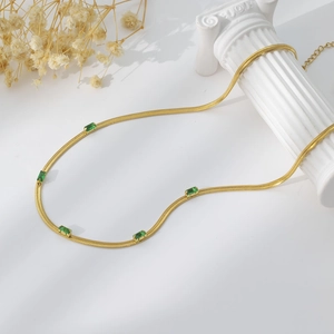 Detail of 18K gold-plated blade chain necklace with five green rectangular zircon stones