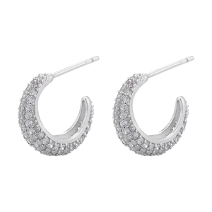 Macro view of C-shaped hoop earrings with pave-set cubic zirconia in polished silver