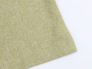 Close-up of light green breathable woven linen fabric texture showing textile details