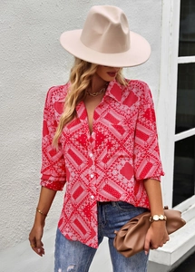 Detail of red paisley long sleeve shirt paired with a wide brim hat and brown clutch