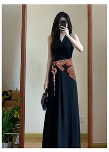 Detail of bohemian paisley print waist belt on a black V-neck sleeveless maxi dress