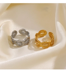 Detail of matte gold and silver braided rings on silk fabric with adjustable open design
