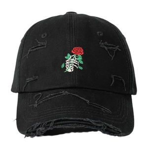 Distressed black baseball cap featuring skull hand holding rose embroidery on front