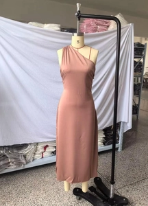 Close-up of pink satin asymmetrical maxi dress showing glossy fabric texture and fit