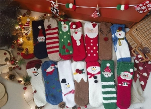 Detail view of colorful festive coral fleece Christmas socks with 3D cartoon characters