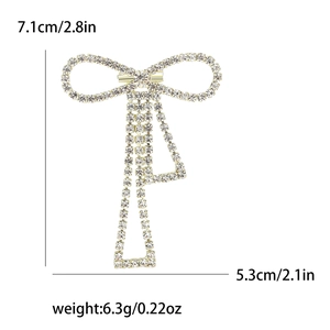 Sparkling crystal bow brooch in gold metal plating with size details 7.1cm by 5.3cm