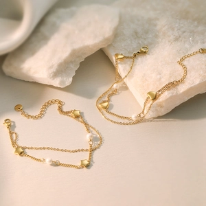 Double-layered gold-plated stainless steel bracelet with heart, star, and pearl charms