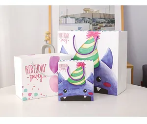 Three sizes of cartoon birthday gift bags with purple monsters and woven rope handles