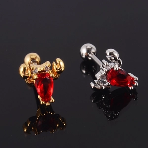 Detail of crab ear studs with red pear-shaped zircon and screw ball back closure