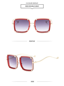 Detail of red square oversized sunglasses with gold metal legs and gray gradient lenses