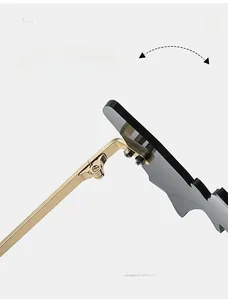Detail of durable gold metal hinges and dark grey bat-shaped lenses on rimless sunglasses