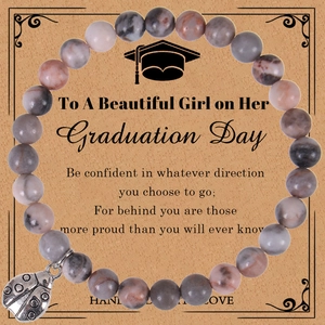 Detail of natural stone bead bracelet with ladybug charm on graduation gift card