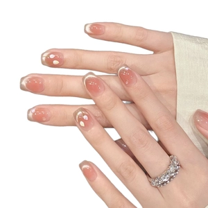 Pink cat-eye gradient press-on nails with floral art and sparkling silver gemstone ring