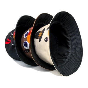 Three bucket hats with cartoon turkey prints in black, brown, and beige cotton canvas