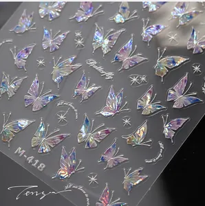 Macro detail of laser holographic butterfly nail stickers with gold accents and stars