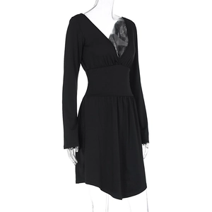 Detail view of the deep V-neckline and belted waist on this elegant black long sleeve dress