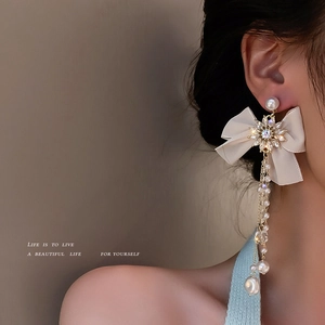 Elegant silver needle asymmetric bow tassel earrings with crystals and hanging pearls