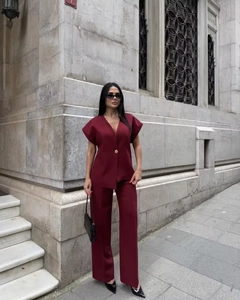 Deep V-neck burgundy two-piece set featuring a sleeveless top and matching wide-leg pants