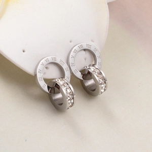 Detailed close-up of silver interlocking rings with roman numerals and square-cut stones