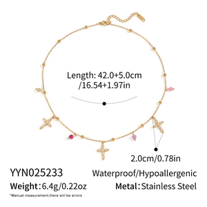 Detailed view of gold stainless steel cross necklace with colorful zircon stones