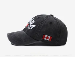 Detail view of washed dark gray denim baseball cap with Canada 1867 embroidery