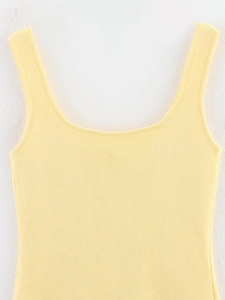 Gros plan sur la texture en tricot fin et l'encolure carrée de ce débardeur jaune
