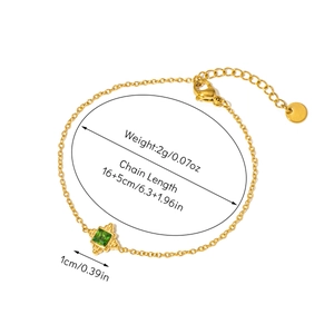 Detailed view of gold chain bracelet featuring a square emerald pendant and size markers