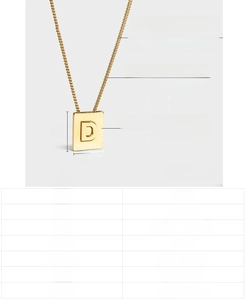Detail of 18K gold-plated stainless steel square pendant with engraved letter D
