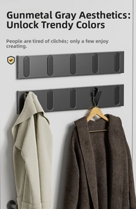 Detail of gunmetal grey folding wall hooks showing dual row installation for coats