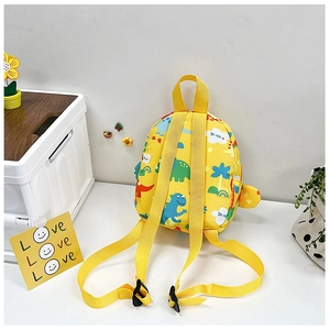 Detail of yellow toddler backpack featuring cartoon dinosaurs and wide adjustable straps