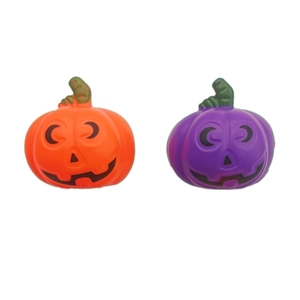 Macro shot of orange and purple Halloween plastic pumpkins with black face painting