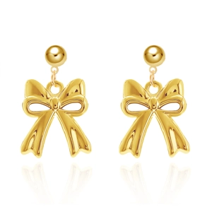 Detailed view of elegant gold bow stud earrings with glossy finish on white background
