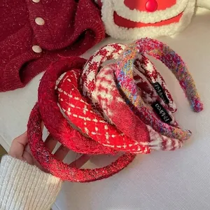 Close-up of thick red tweed braided headbands in various plaid patterns for winter