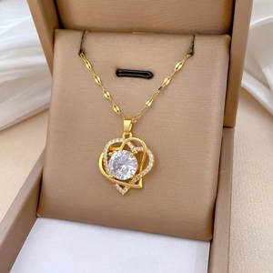 Close-up of a luxury gold heart necklace with a large crystal in a premium display box