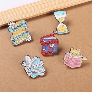 5-piece cartoon cat and book enamel pin set for backpacks, featuring hourglass and reading theme