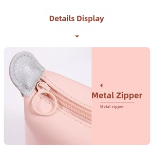 Detail view of pink waterproof cosmetic bag with metal zipper and leather snap closure