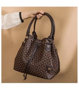 Detail of vintage brown bucket bag with geometric triangles and drawstring closure