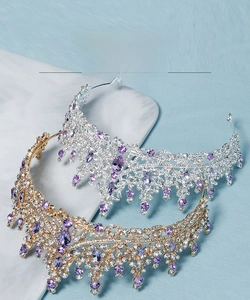 Close-up of luxury bridal crowns with purple crystals in gold and silver finishes
