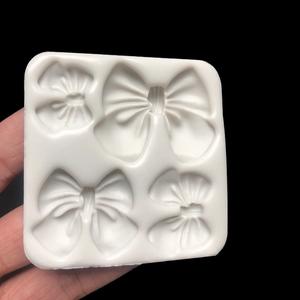 Silicone mold with four different bow shapes for DIY chocolate and fondant baking
