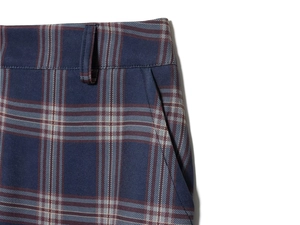 Detail of waist design and side pocket on navy blue plaid cargo pants with belt loops