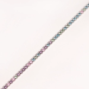 Detail of tennis bracelet featuring a row of colorful pink, purple, green and blue zircons